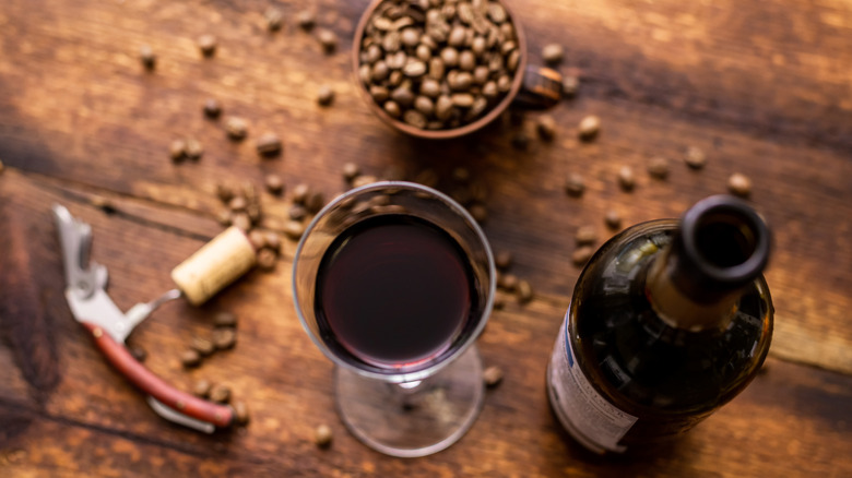 Coffee beans around a wine glass