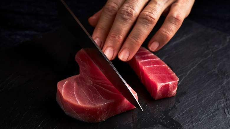Chef slicing raw tuna 