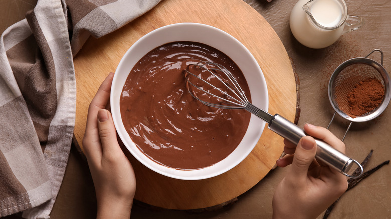 Overhead view of person whisking melted chocolate