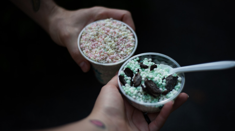 hands holding Dippin' Dots cups