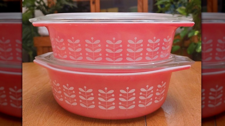 Two vintage Pyrex Pink Stems casserole dishes with glass lids