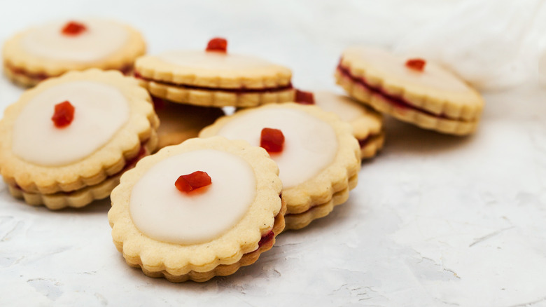 Empire biscuits in a pile on a white cloth