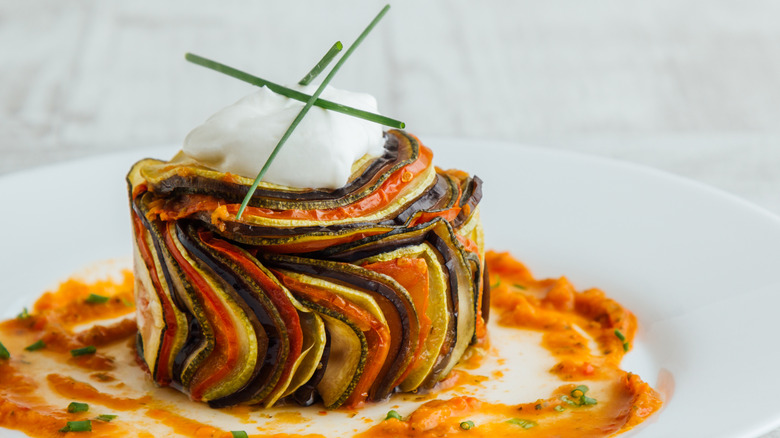 Confit byaldi with saucework on white plate