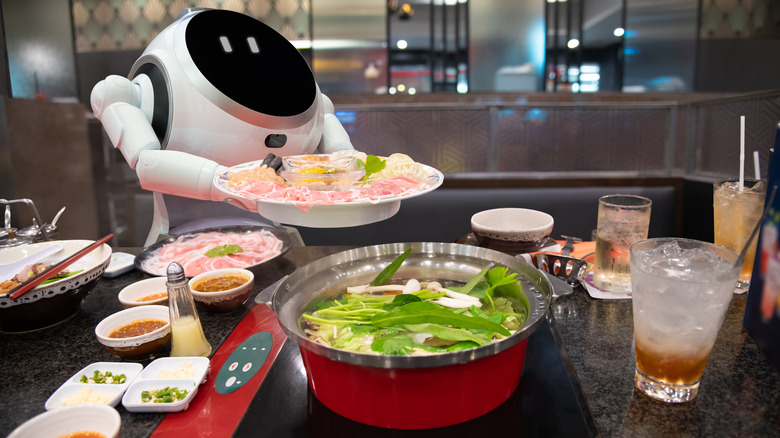 A robot serving a plate of food