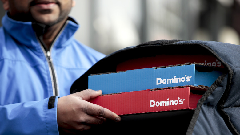 employee delivering Domino's