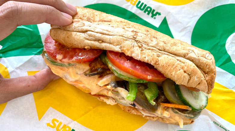Hand grabs Subway sandwich