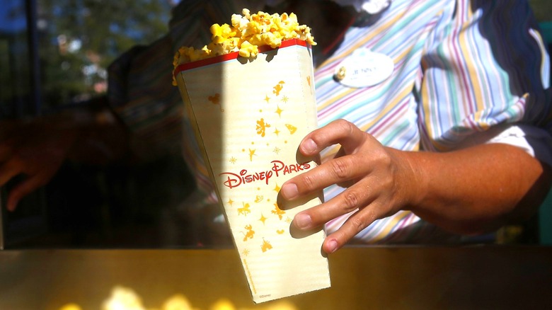 Disney worker holding popcorn