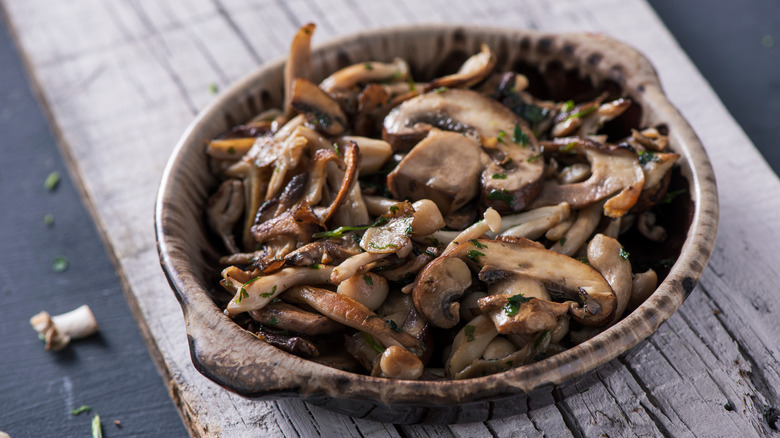 cooked mushrooms in brown bowl