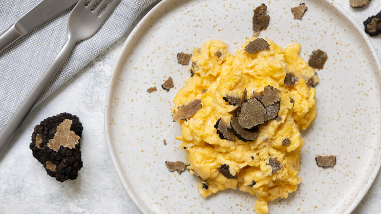 scrambled eggs with shaved black truffles on plate