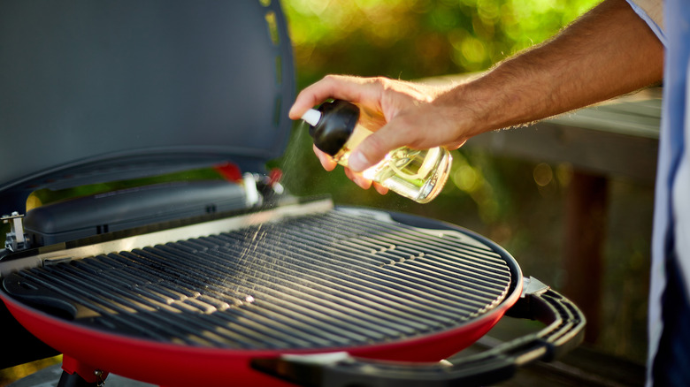man oiling grill grates