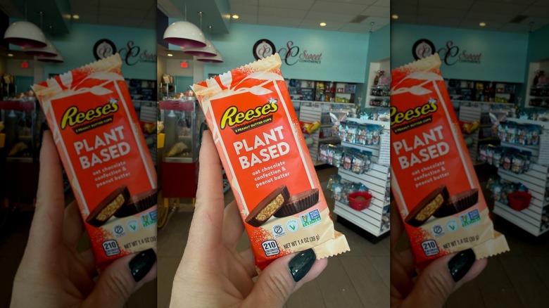 Hand holding Reese's Plant Based Oat Peanut Butter Cup in store