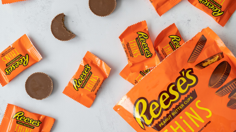 Reese's peanut butter cup thins spread over a white surface