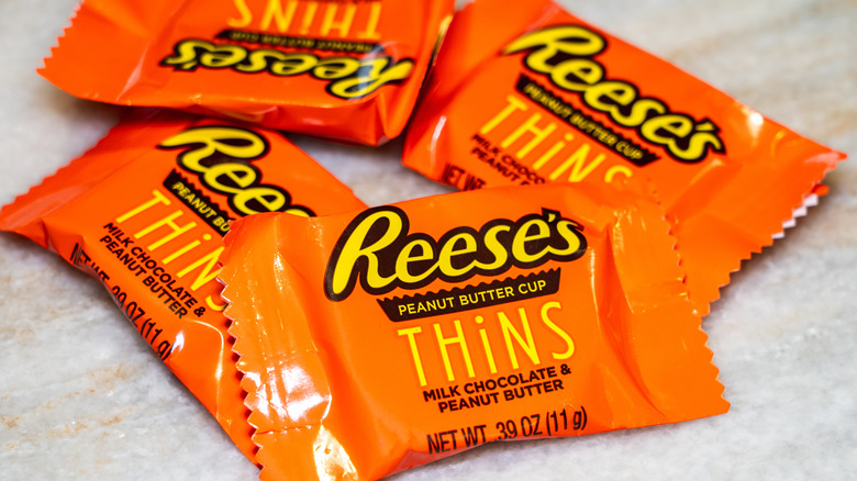 Reese's Peanut Butter Cup Thins in wrappers on table