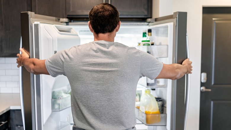 man opening refrigerator 