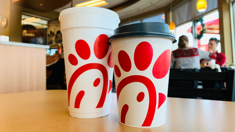 Chick-fil-A drinks, including coffee, at a busy restaurant.