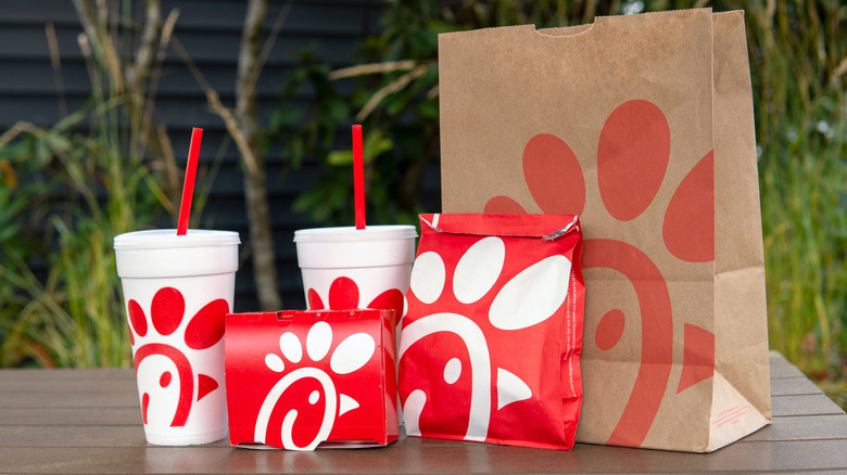 Chick-fil-A food and beverage packaging outside.