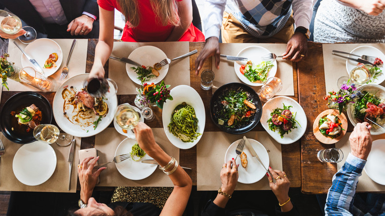 Top view of a full dining table with people eating