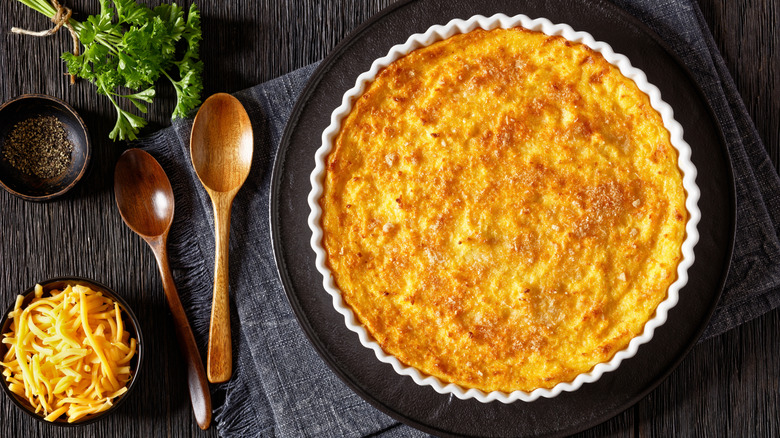 Scalloped corn casserole in a baking dish