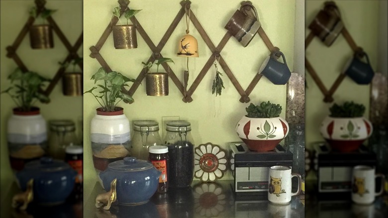 Mugs, planters hung on accordion rack