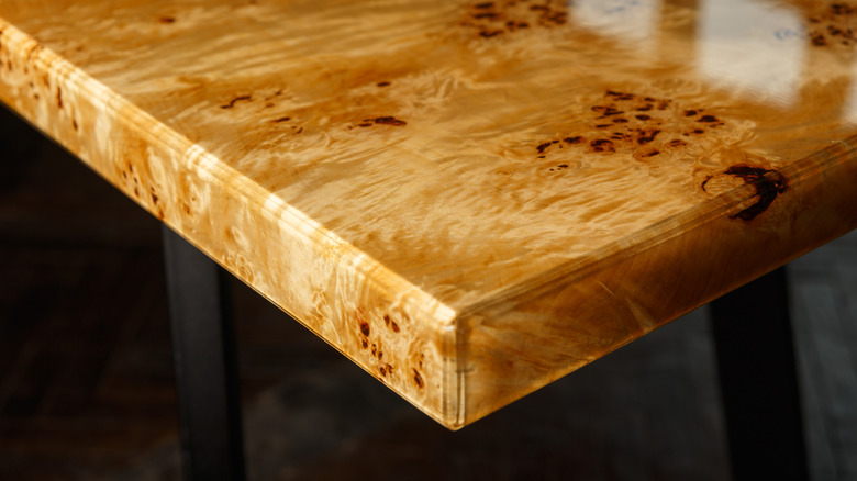 A golden brown burl wood tabletop