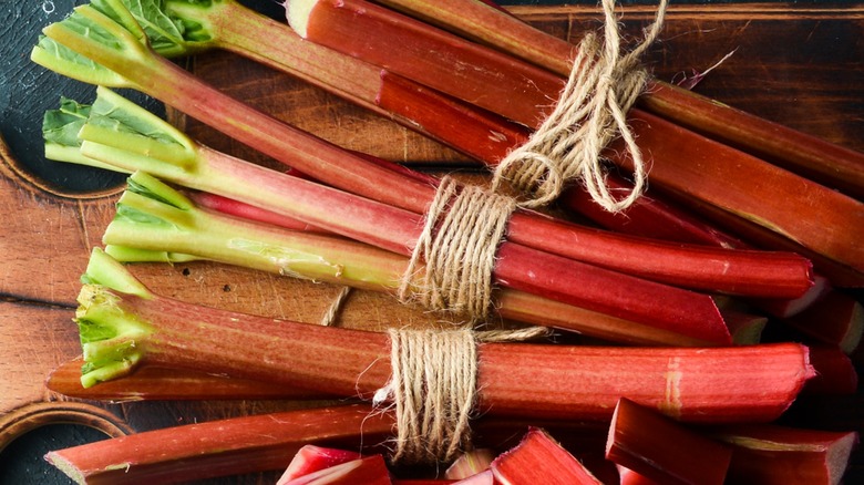 Close-up of fresh rhubarb stalk bundles tied with twine