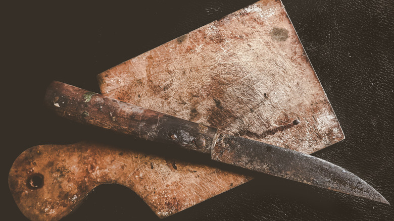 Rusty knife on cutting board