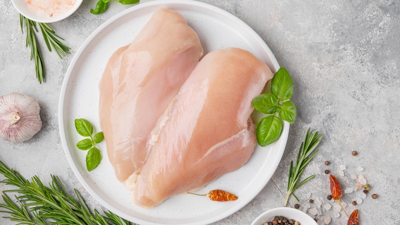 raw chicken breasts on plate