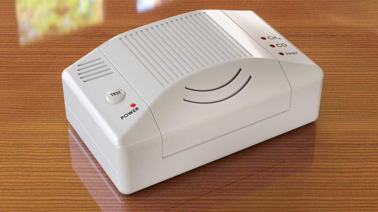 A combination carbon monoxide and methane gas detector on a table