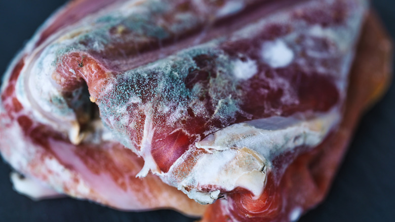 A closeup of ham with mold
