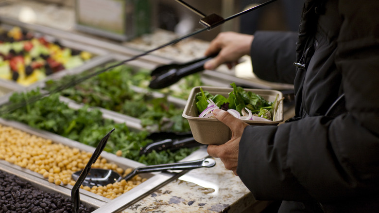 customer preparing whole foods salad