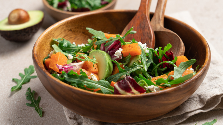 bowl of fresh arugula salad with beets and feta