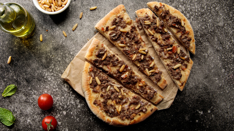Pizza with beef and pine nuts