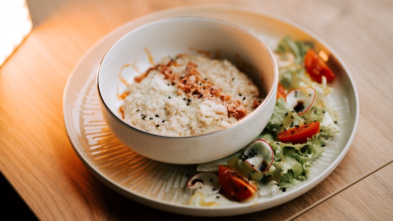 Savory oatmeal served with salad
