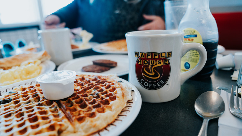 a Waffle House meal with coffee cup, waffle, and side dishes