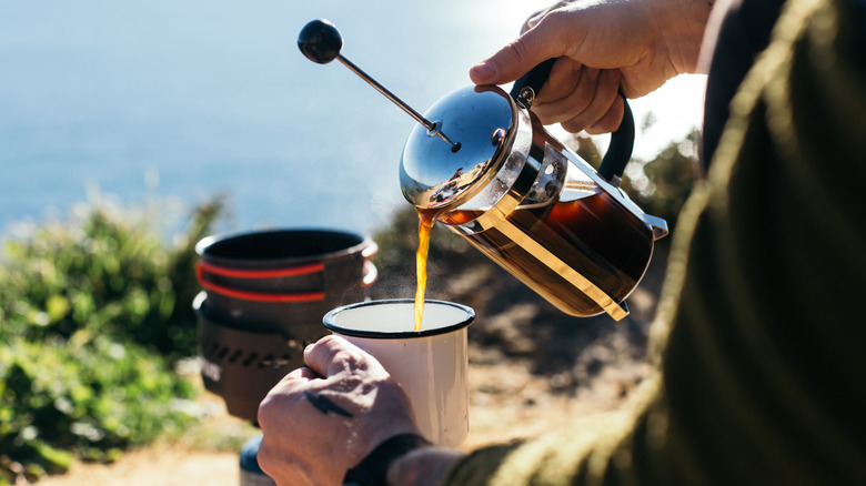 pouring french press coffee outdoors