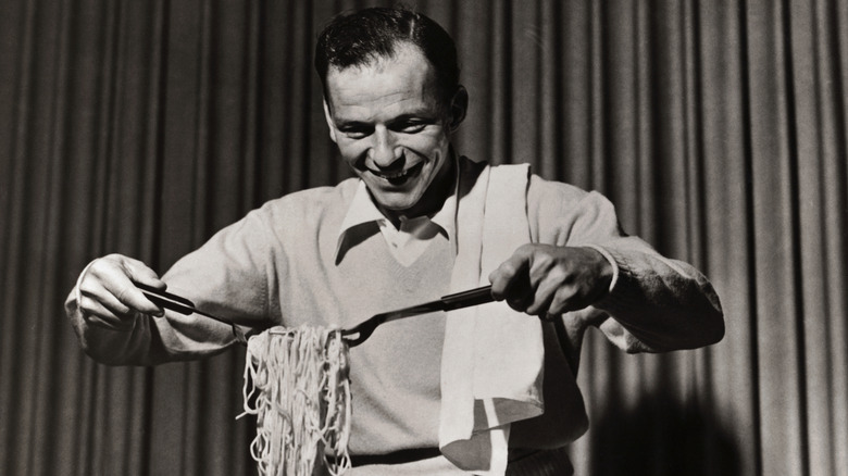 Frank Sinatra holding some spaghetti
