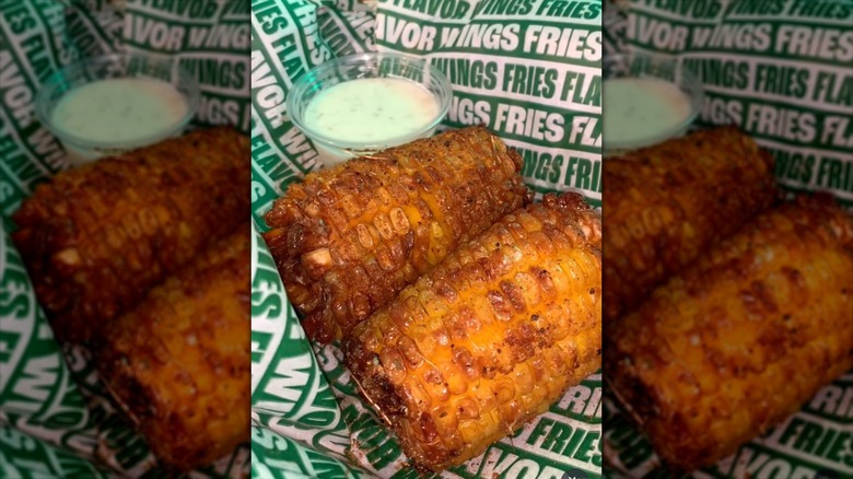 Wingstop's Cajun corn in basket with dipping sauce