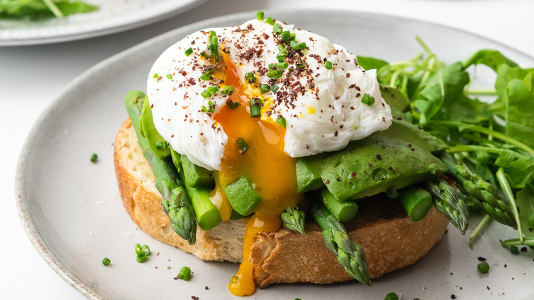 avocado toast served with egg and sumac