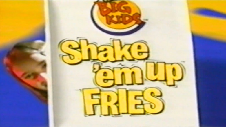 A child holds a bag of Shake 'Em Up fries from Burger King
