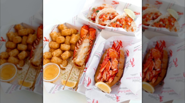Lobster rolls, tacos, and tater tots from Cousins Maine Lobster in paper lined containers