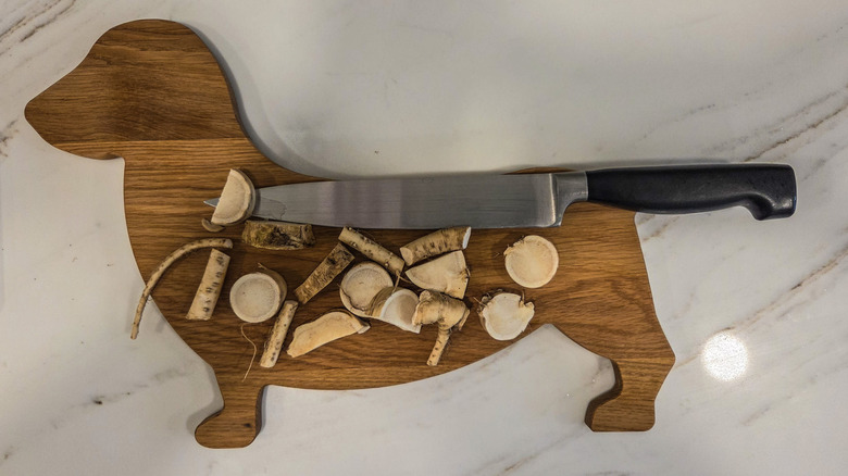 cut up fresh horseradish on a cutting board