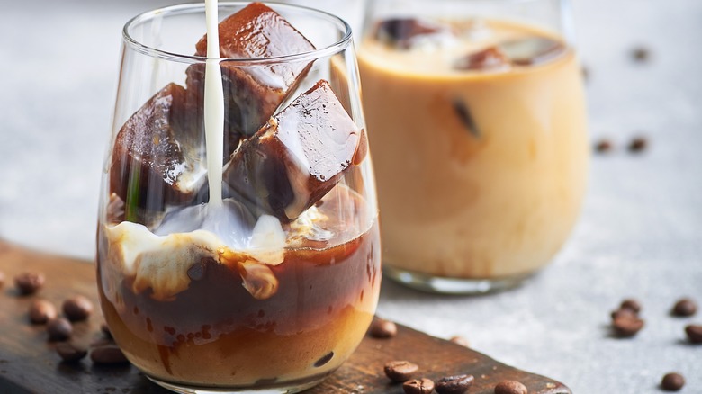 pouring milk in iced mocha drink