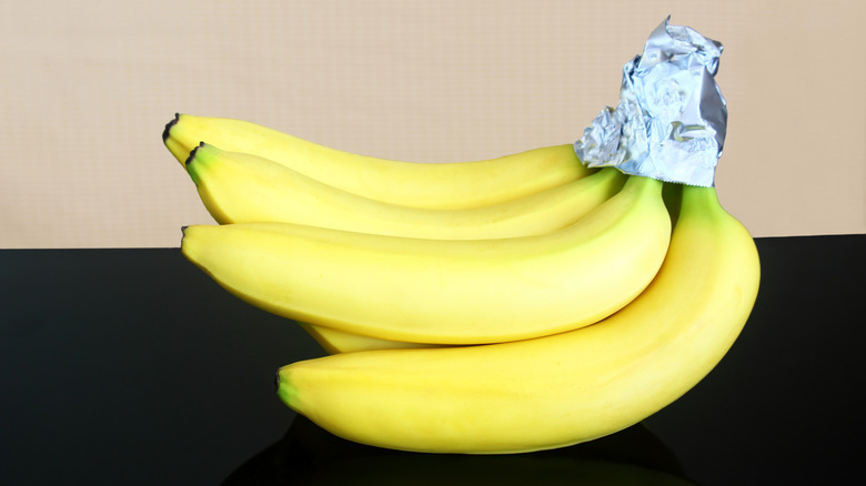 Bunch of bananas with foil wrapped stems
