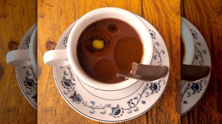 cup of hot chocolate with butter melting in it