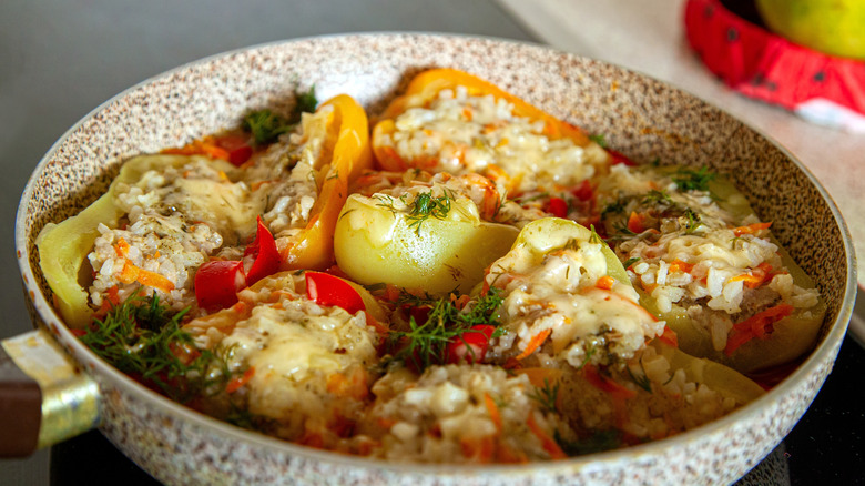 Braised stuffed peppers in a pan