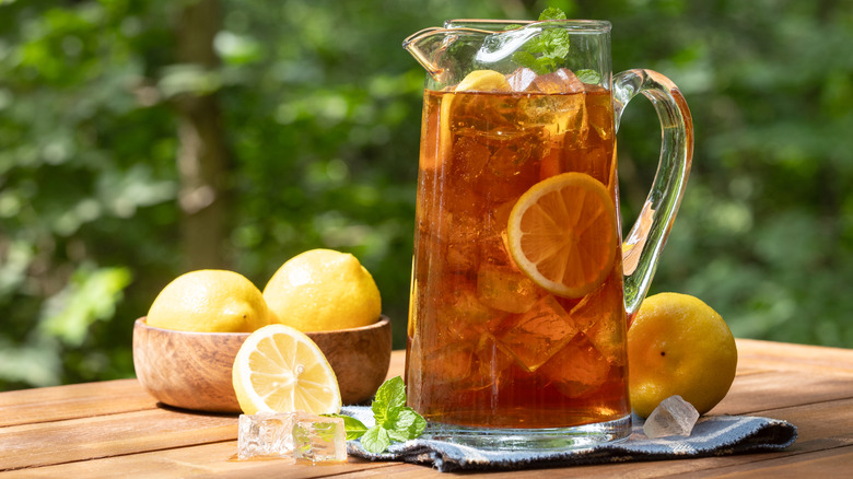 Pitcher of sweet tea surrounded by lemons