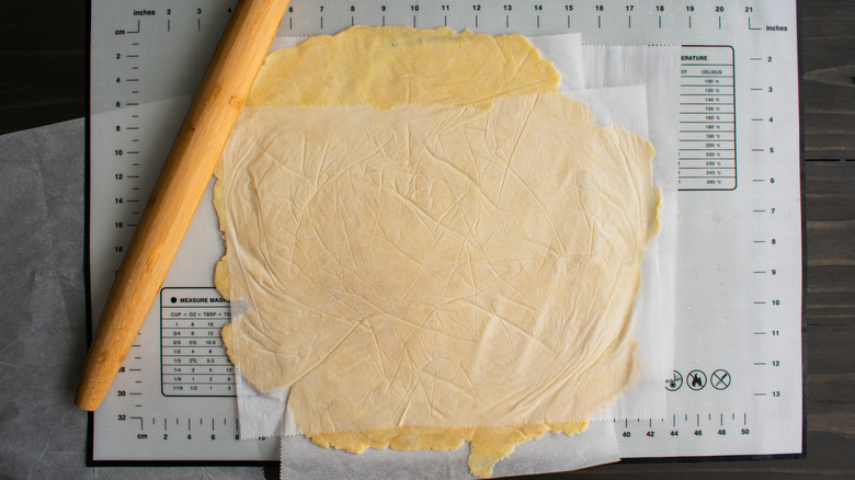 pie dough between parchment