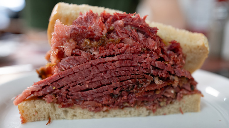 A stacked pastrami sandwich on rye bread
