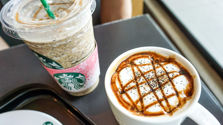 Starbucks drinks with honey on top next to pancake on plate