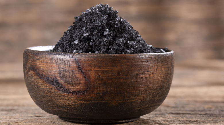 Black salt in wooden bowl